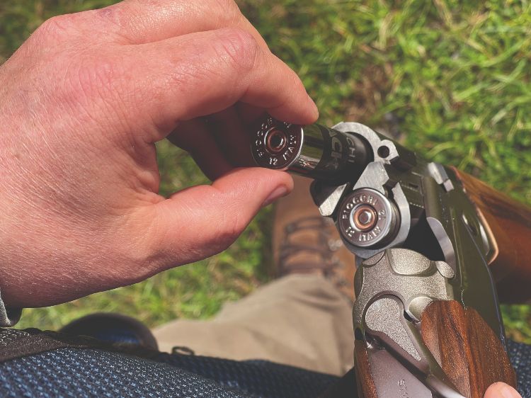 Fiocchi F Black shotgun cartridge being loaded into a gun