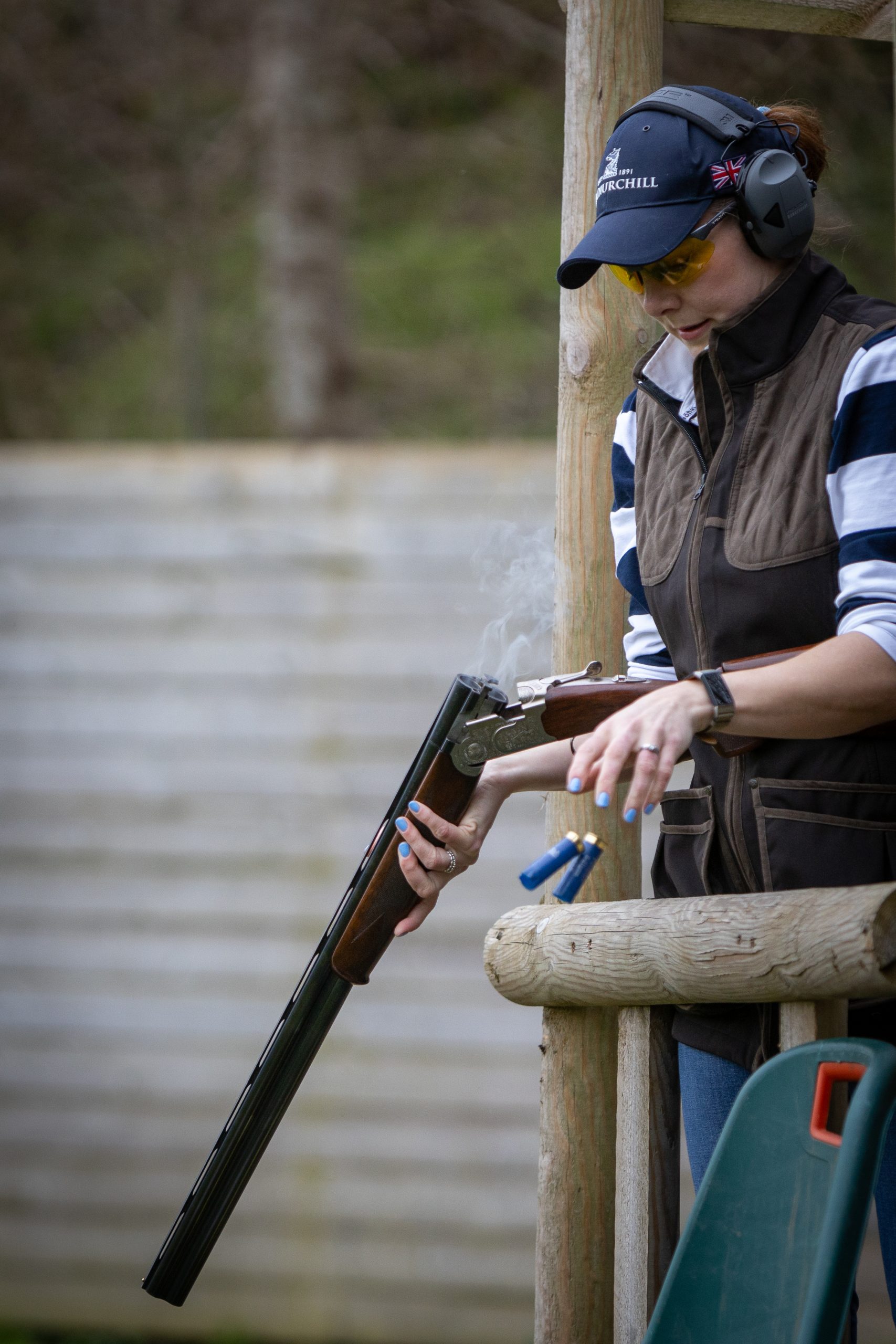 Woman dropping her cartridges out of her gun