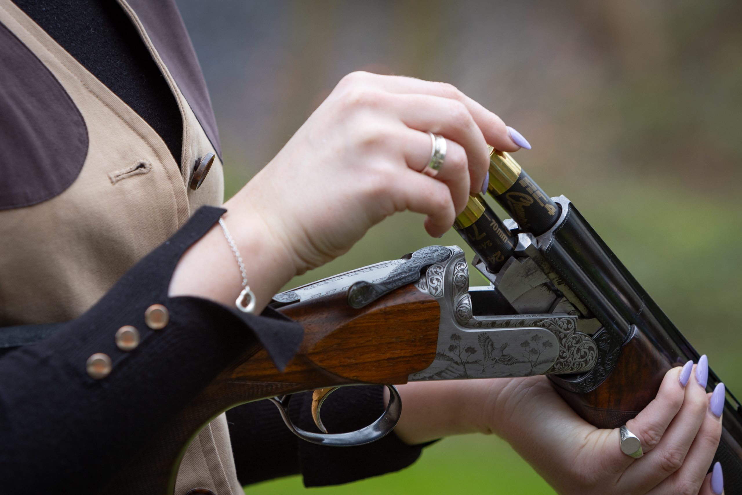 A woman loading cartridges into her gun