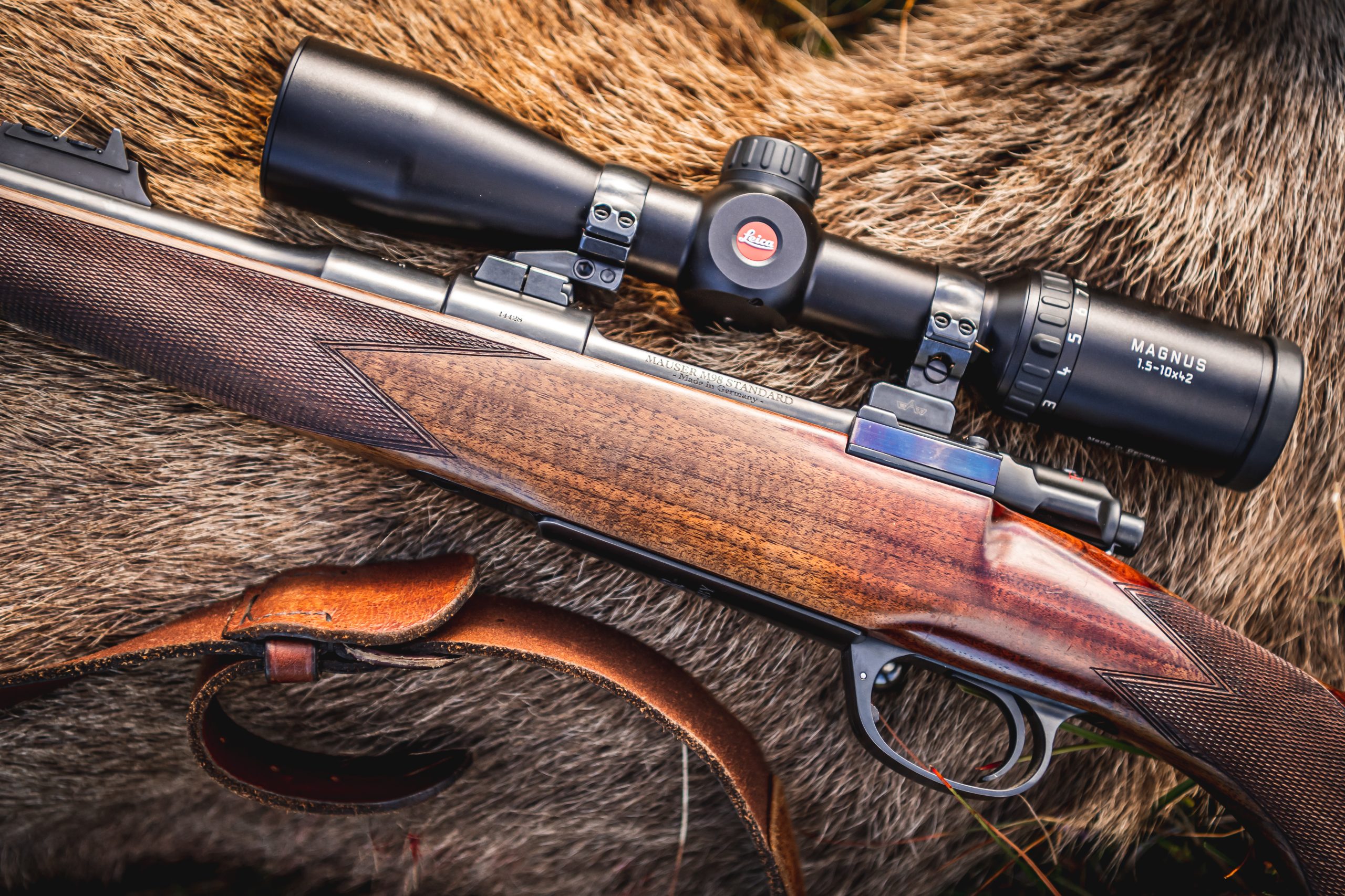 Rifle laying next to fallen red stag