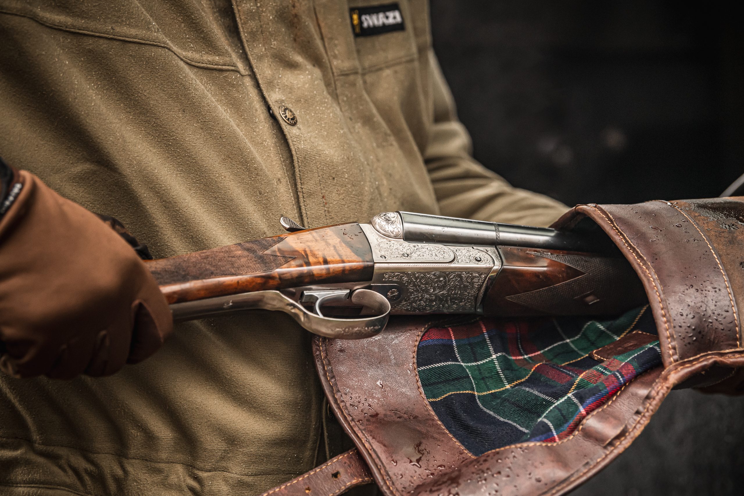 A man pulling his gun out of its slip