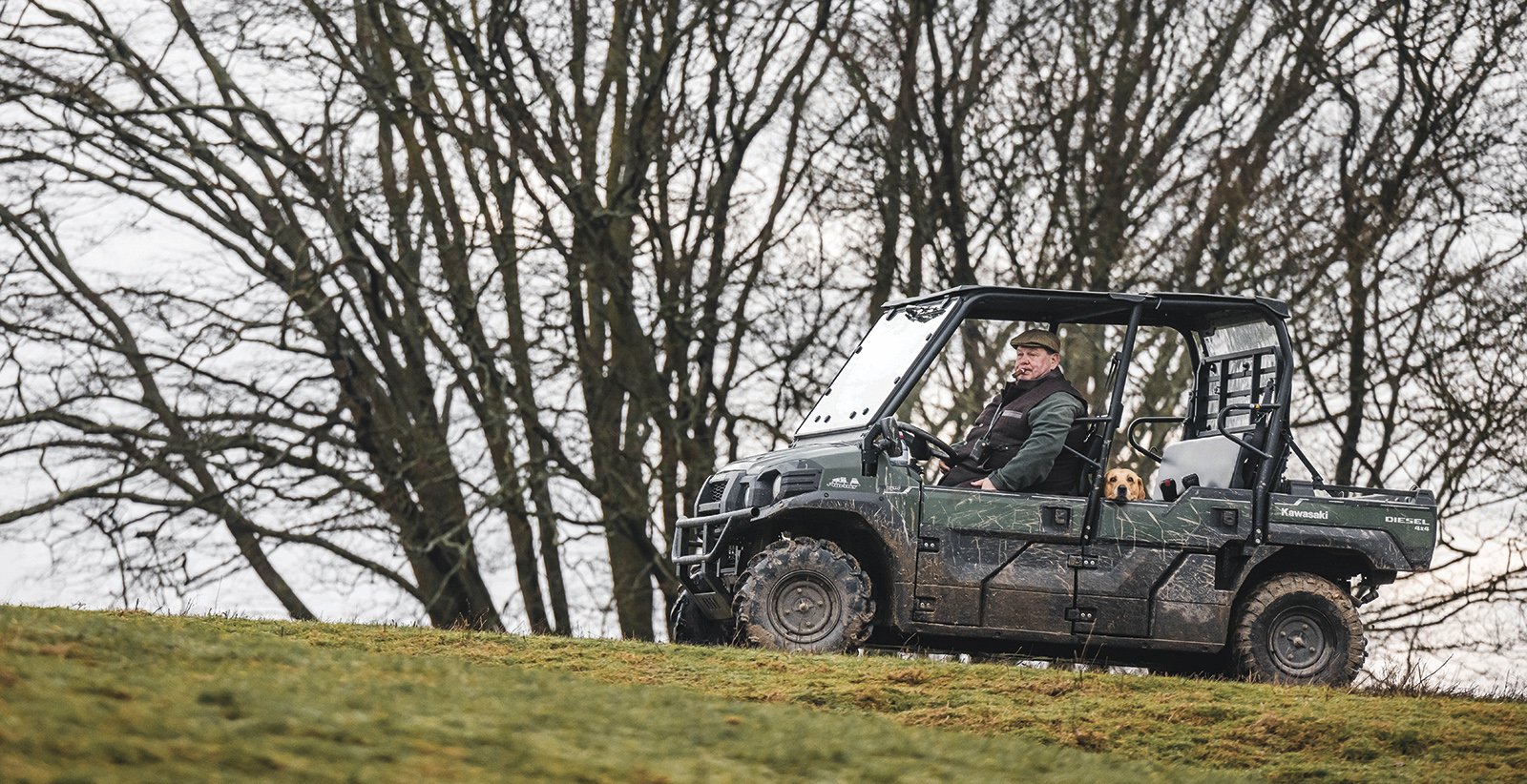 George Digweed driving a utility vehicle across open countryside