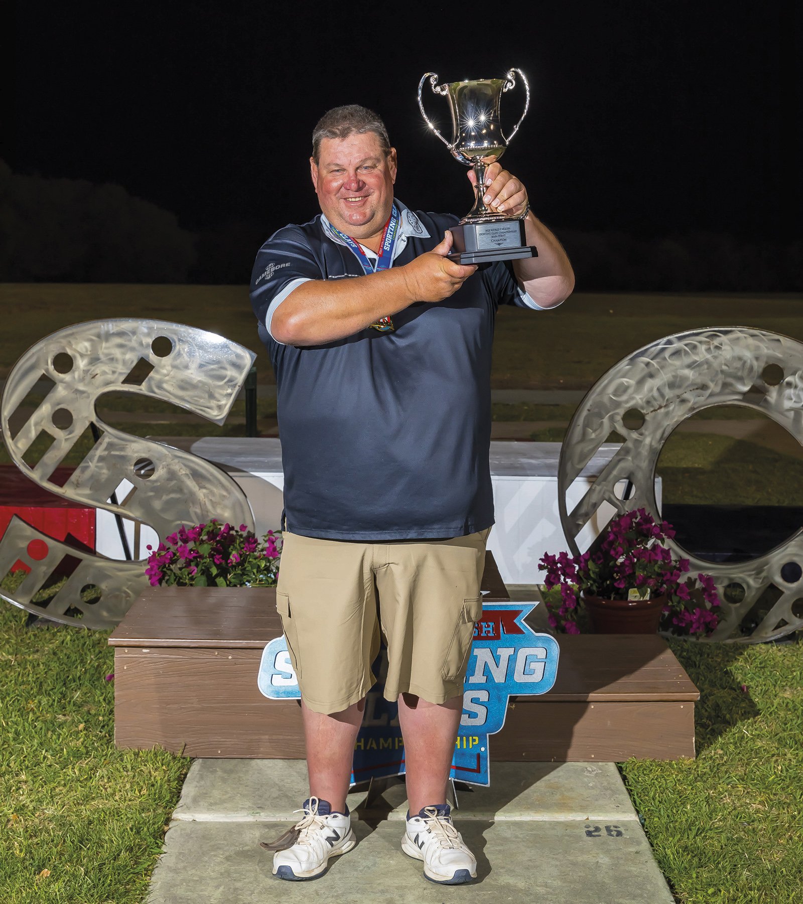 George Digweed MBE holding a world championship trophy at a clay shooting competition
