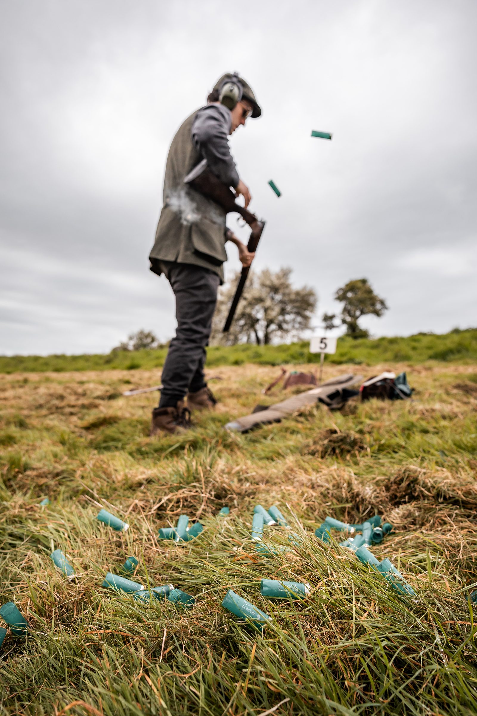 A Gun reloads beside spent cartridges at peg five on a simulated game day at Great Tew Estate