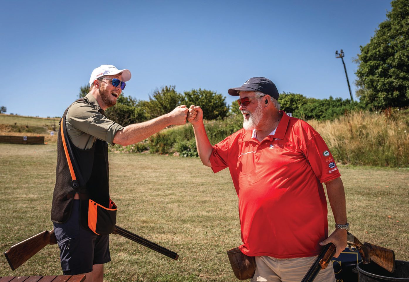 Jonny Carter sharing a fist bump with an official at a clay shooting ground