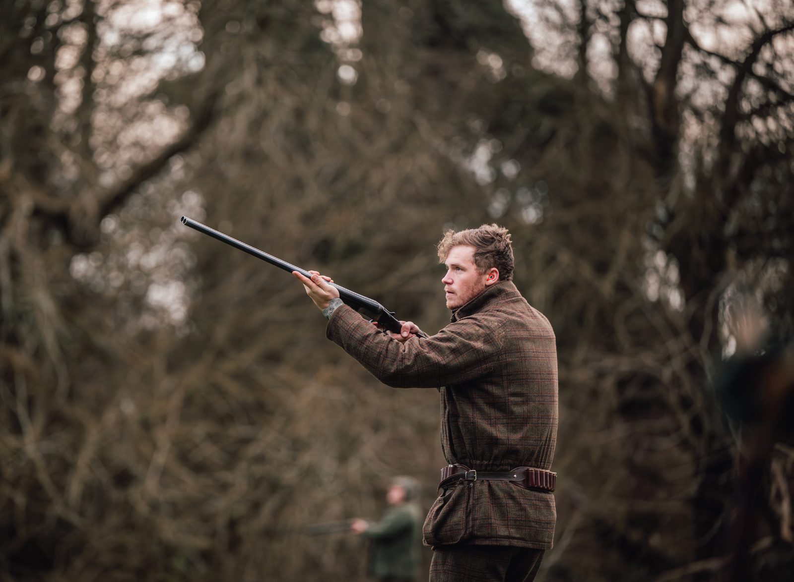 Jonny Carter mounting an over-and-under shotgun on a driven game day