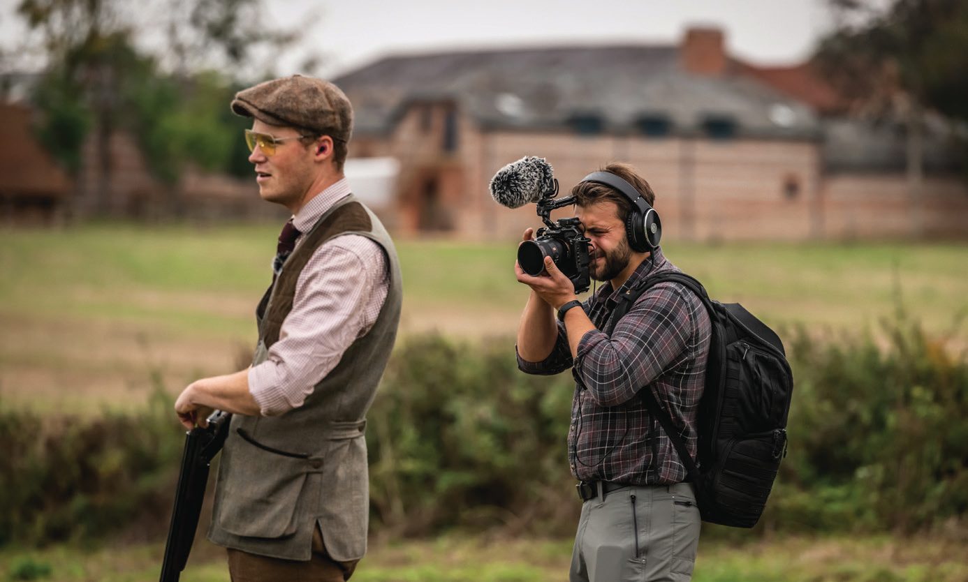Jonny Carter standing beside cameraman Sasha filming for TGS Outdoors