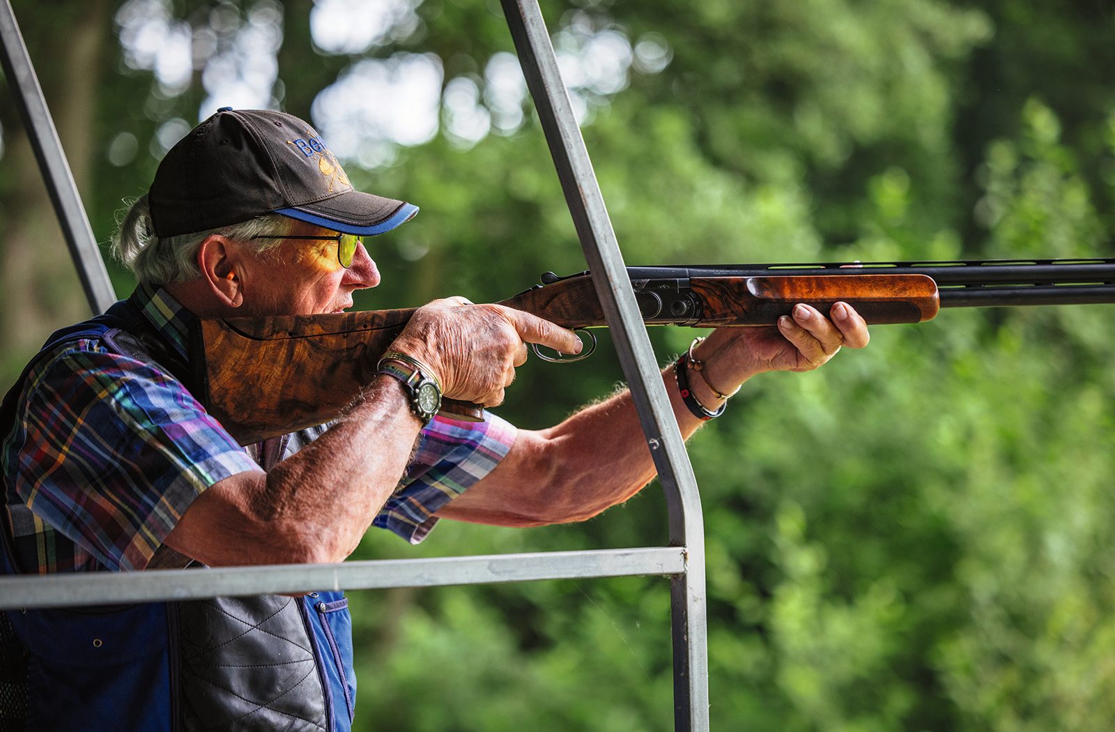 Clay shooter mounting an over-and-under shotgun during tuition at High Lodge in Suffolk