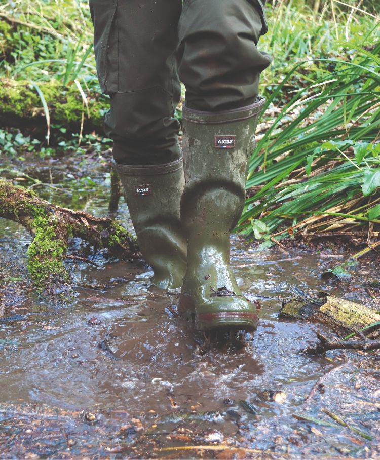 Wellies splashing through a puddle